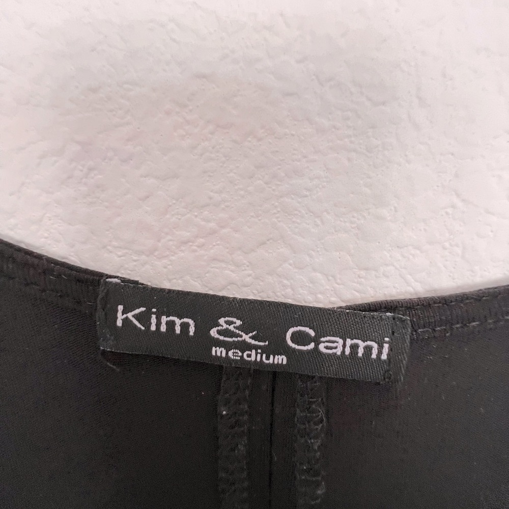 Black blouse with sheer inset in back.